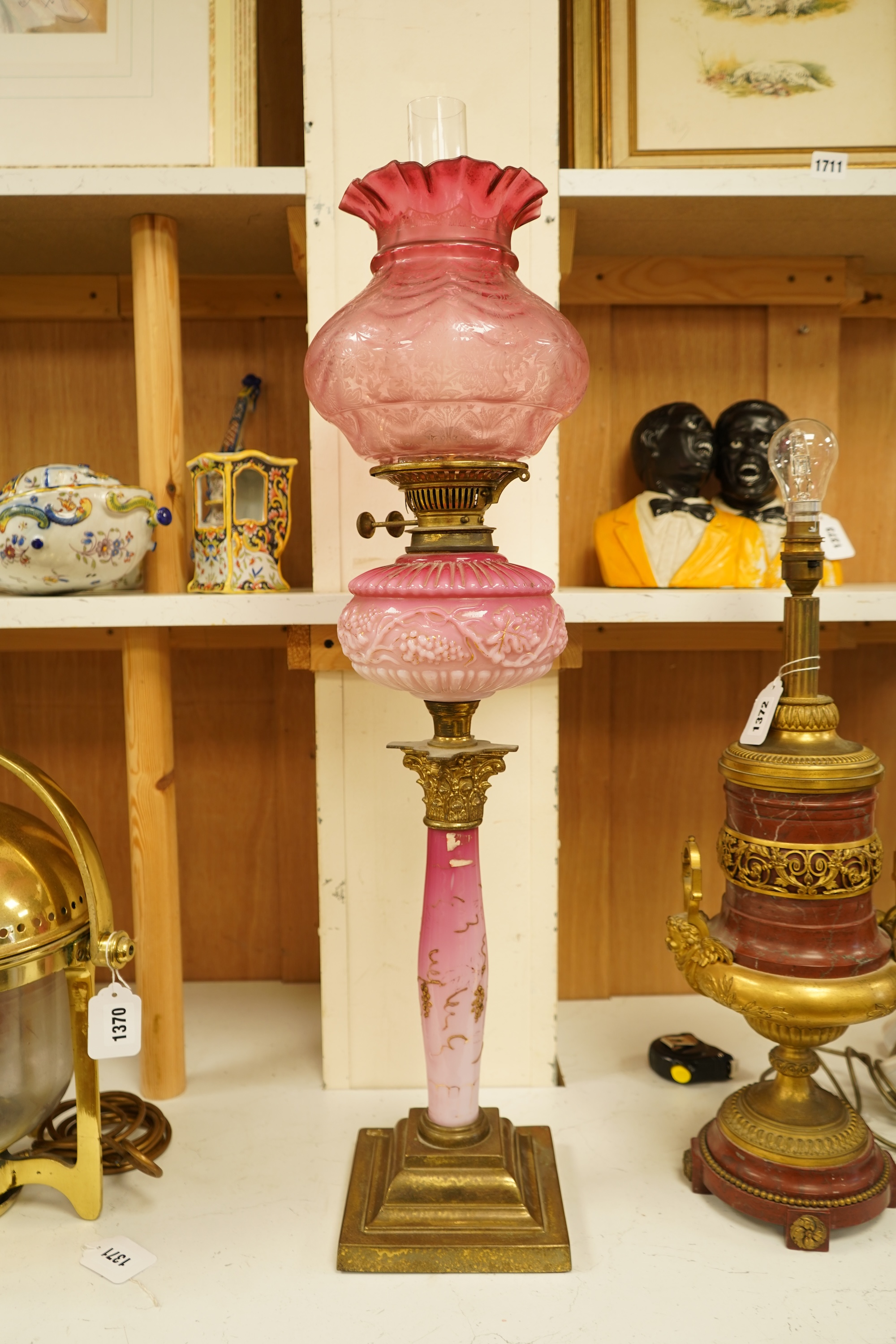 A Victorian brass and ruby glass oil lamp, 80cm high overall